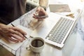 Close-up of manÃ¢â¬â¢s hands using smartphone, making notes, opened laptop sitting in cafe having coffee. Concept of young business Royalty Free Stock Photo